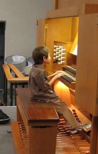 A young performer playing the organ