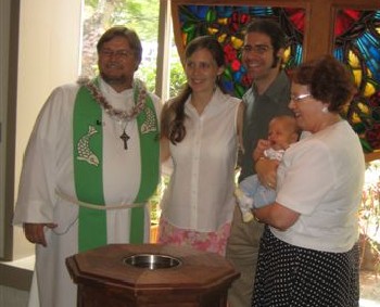 Pastor Jeff Lilley with parents Sean and Charlotte D’Evelyn and sponsor Olivia Castro holding the baby.