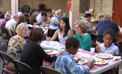 Members and friends enjoy food and fellowship in the courtyard.