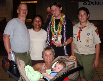 The Schmidts and Peggy Anderson say aloha at the airport