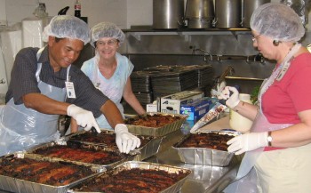 Cutting the meatloaf to be served at IHS