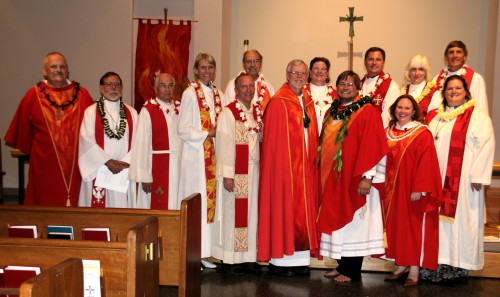 The clergy at the installation all dressed in red