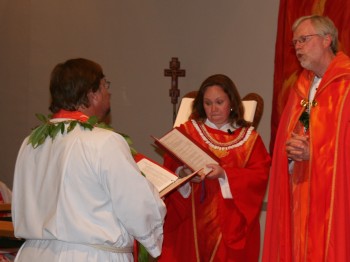 Bishop Finck, assisted by former LCH Intern Katy Grindberg, examining Pastor Lilley.