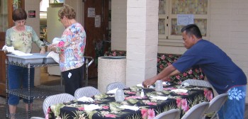 Members of the Fellowship Committee set tables for dinner