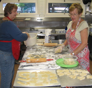 Jeanette Hansen and Ilse Layau of the Fellowship Committee roll, cut, and bake cookies for the Sunday School Epiphany celebration.