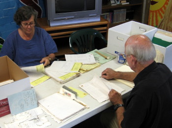 Volunteers cleaning material from the archives