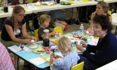Children and adults experiencing the various Seder foods