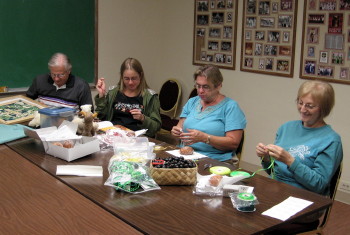 In Stitches members working on their own crafts and church projects.