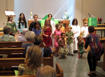 Teresa McCreary directs the children in “The Holy Trinity” for the introit