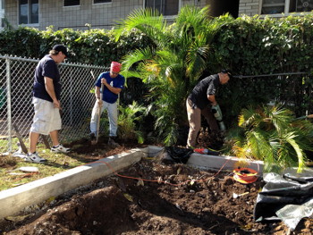 Pr. Jeff and volunteers take care of landscaping after reinstalling the preschool fence