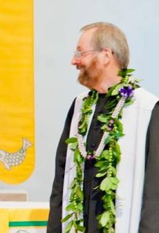Cantor Carl Crosier, bedecked in lei, at his farewell service