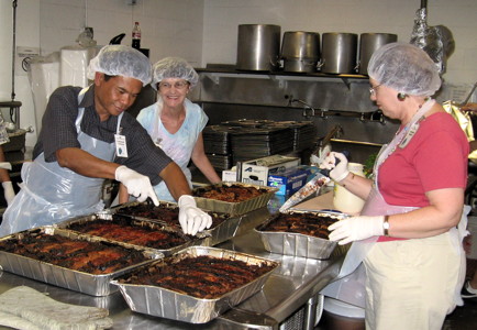 Members serve dinner to the guests at IHS, a full-service homeless shelter in Honolulu, on the third Friday of every month.