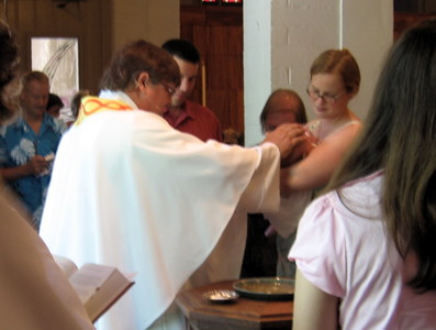 A baby is welcomed into the family of Christ through the Rite of Baptism.