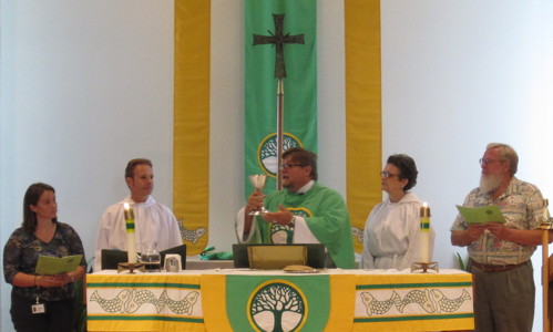 Pastor Jeff Lilley celebrates communion assisted by ministers from the congregation.
