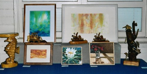 A variety of paints and several types of paintings on display