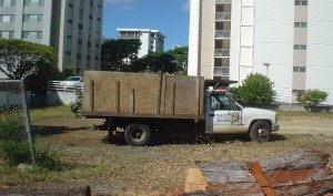 The contractor's truck arrives to begin hauling away debris.