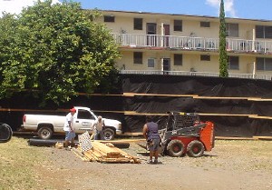 Workers put up the dust screens.