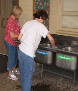 Mary Jo Estes and Billie Jean Ries clean the new sink