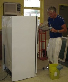 Bob Tellander cleaning one of the refrigerators