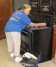 Judie Boutá cleaning the stove