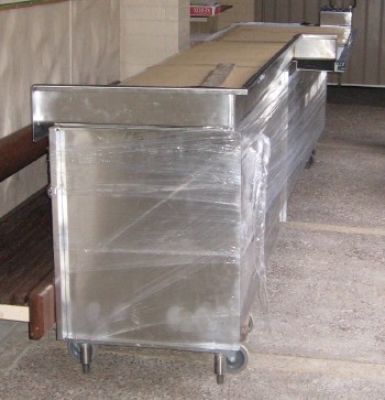 The custom-fabricated shelf unit to fit under the pass through to Isenberg