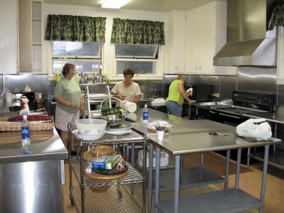 Jeanette Hanson, Pam Bukuli, and Judie Boutá get everything stowed away in the kitchen. Jeanette Hanson, Pam Bukuli, and Judie Boutá get everything stowed away in the kitchen.