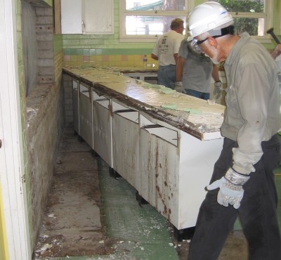 Steve Miller looks at 50 years of debris behind the cabinets.