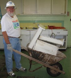 Randy Christensen hauls cabinets out to the parking lot.