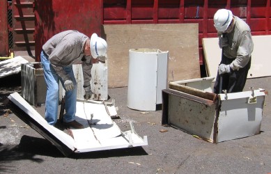 Don Person and Steve Miller collapse some of the cabinets.