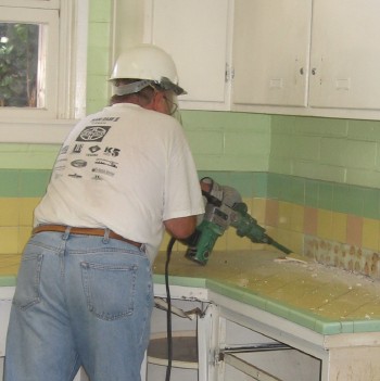Randy Christensen using the chipping guy to remove the back splash tiles