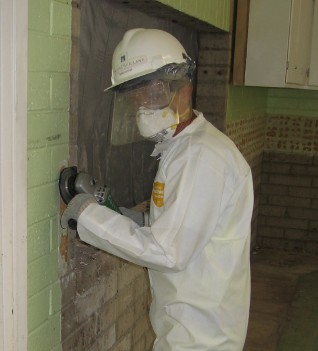 Jim Sullivan in his hazmat suit grinds the walls smooth