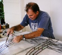 Randy Castello solders the windows together