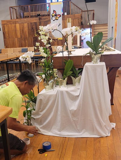 Orchids at the altar are delicate reminders of hope, life, and resurrection.