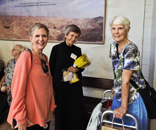 Gathering in the Courtyard, featuring Carol's poster.