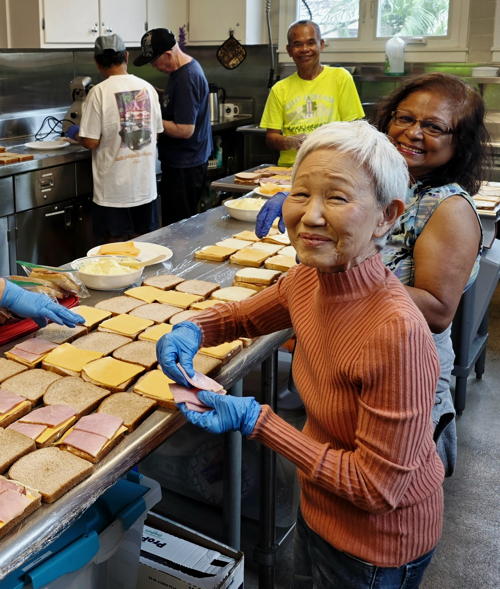 Liane Sakai makes sandwiches for IHS.