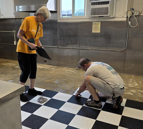 Rev. Phyllis and Rich re-tiling the kitchen on a work day.