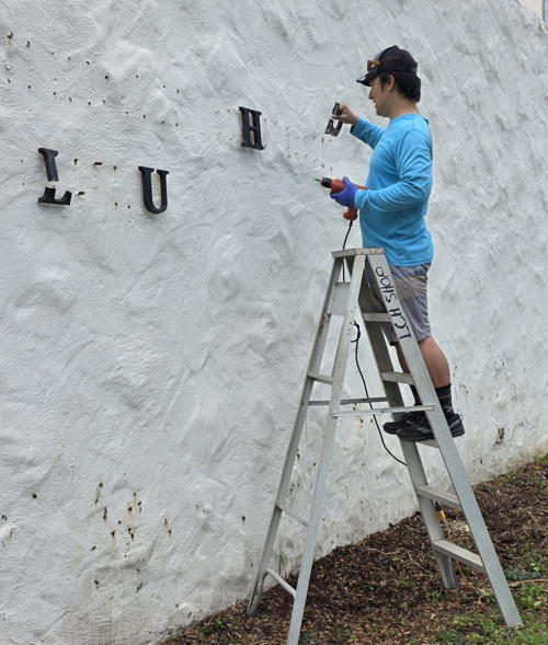 Taking down our old sign to prepare for the mural.