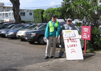 Lars Tellander and Cheryl Crosier-Garcia during Punahou Carnival Parking, watching over the full back lot.