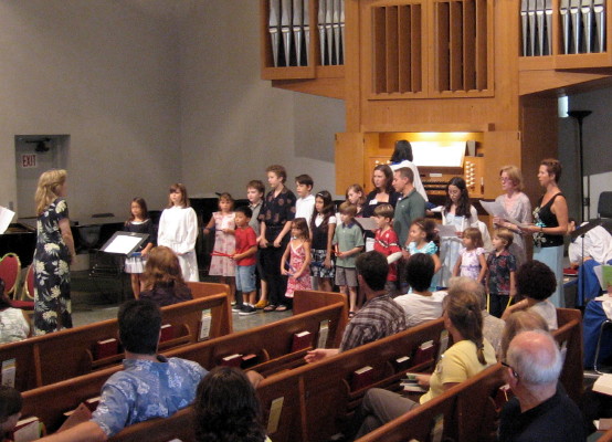 The F.R.O.G.S. Choir and Chamber Orchestra singing an anthem.