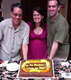 Our three new members show off the cake in their honor