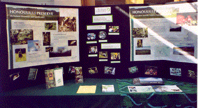 Deacon and Alala chat prior to worship in front Courtyard displays for Earth Day.