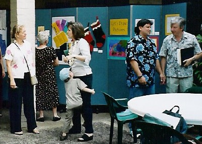 Members and friends look at the displays.